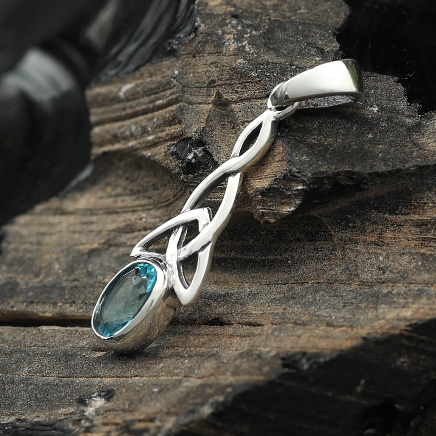 Delicate Celtic knot pendant set with blue topaz and cubic zirconia in 925 silver